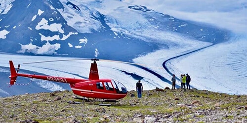 Helicopter tour landing on mountaintop in Alaska